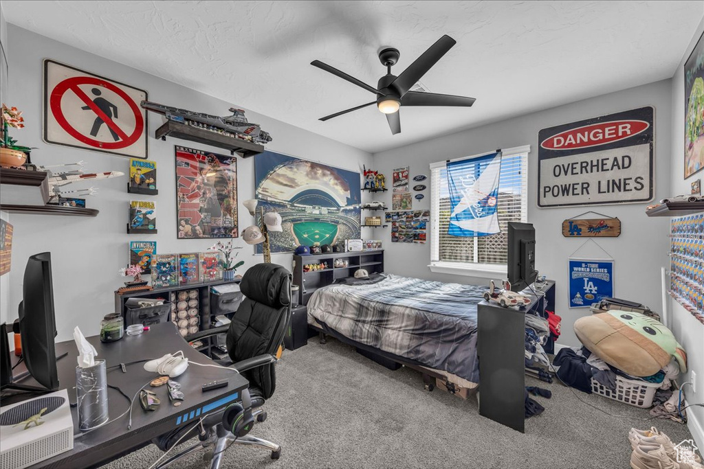 Bedroom with carpet floors, a desk, and ceiling fan
