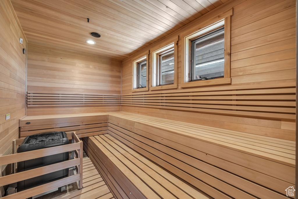 Sauna featuring wooden walls, wooden ceiling, and recessed lighting