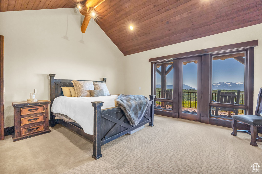 Bedroom with carpet floors, access to outside, wood ceiling, multiple windows, and high vaulted ceiling