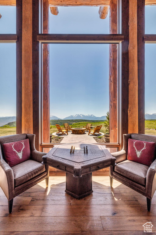 Sitting room with a mountain view and hardwood / wood-style flooring