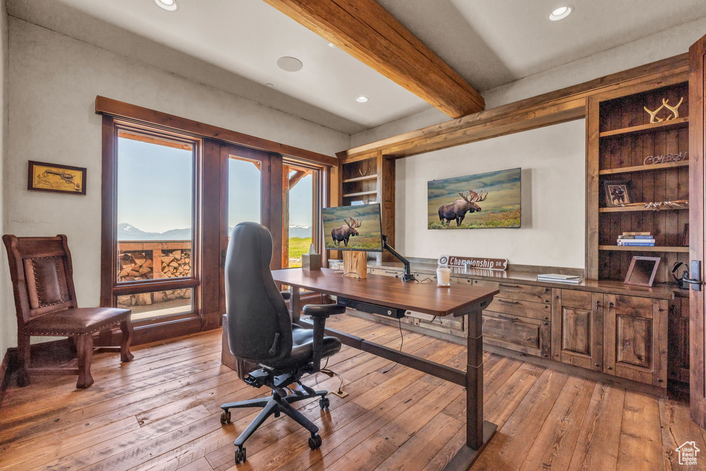 Home office featuring beam ceiling, light wood finished floors, and recessed lighting