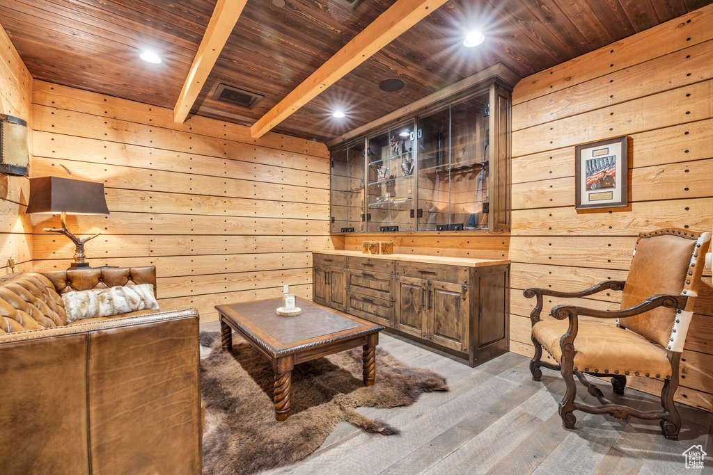 Living area with wooden ceiling, wood walls, wood-type flooring, and recessed lighting