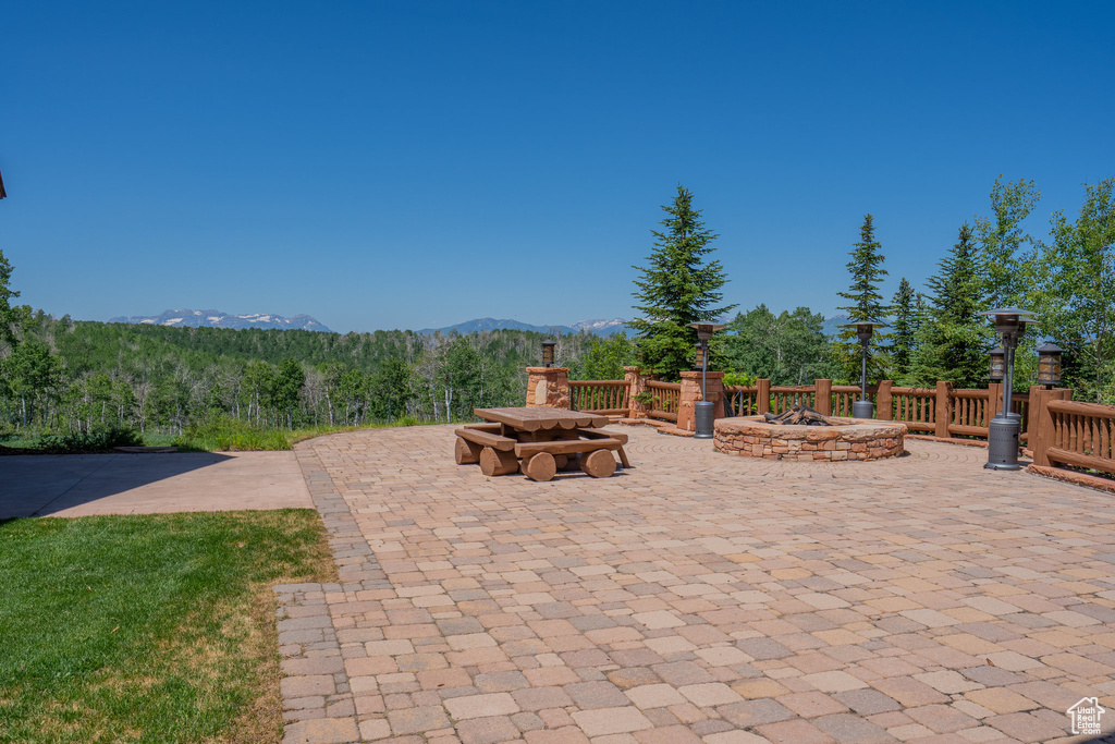 View of patio featuring a fire pit and a mountain view