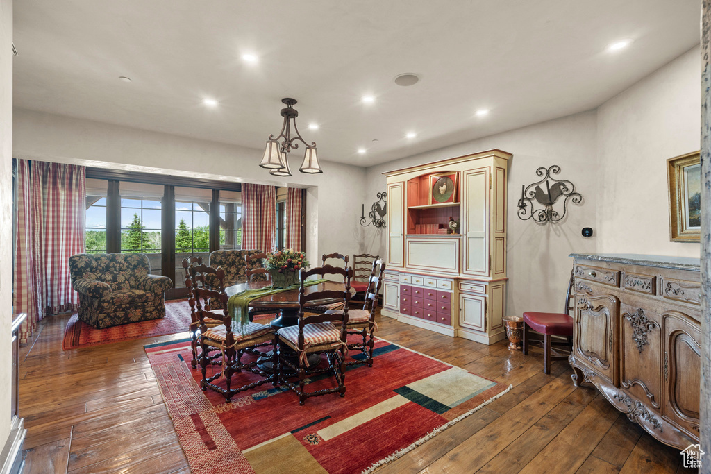 Dining space featuring dark wood-style flooring and recessed lighting