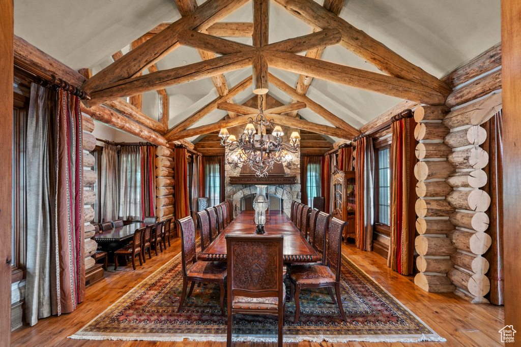Dining room featuring rustic walls, a chandelier, and hardwood / wood-style floors