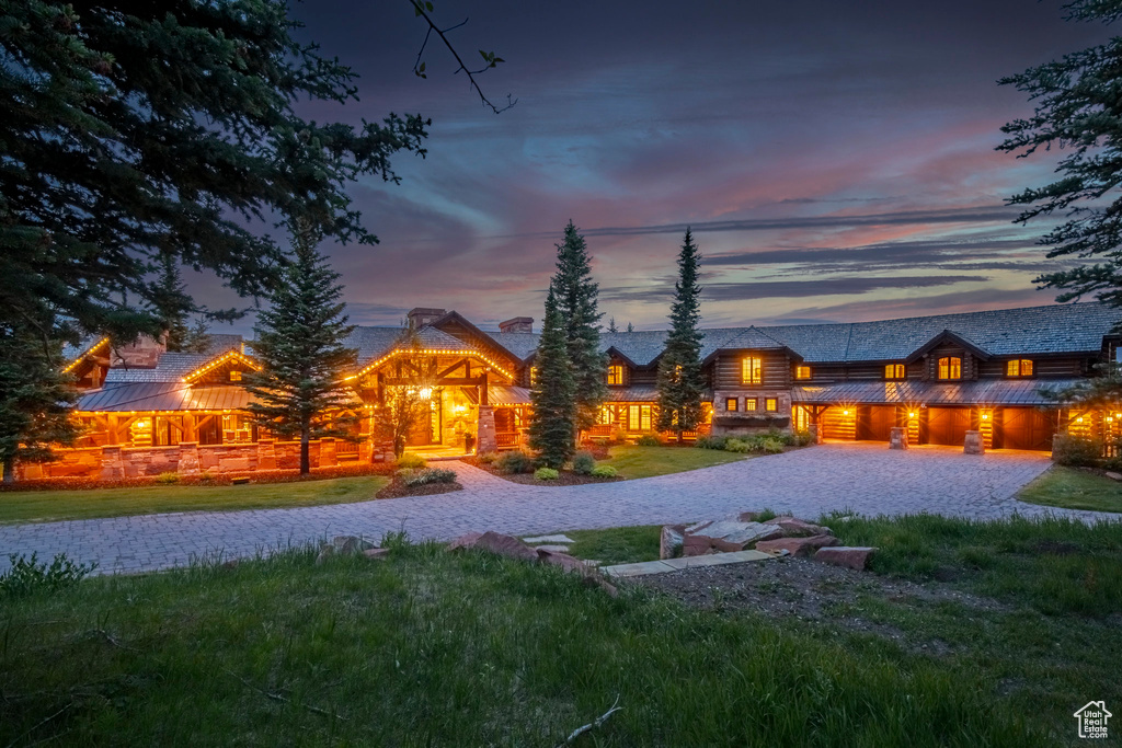 View of front of house with a standing seam roof, a front lawn, and a metal roof