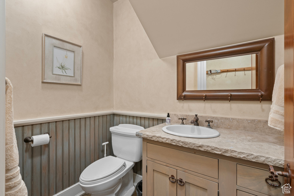 Bathroom with vanity and a wainscoted wall
