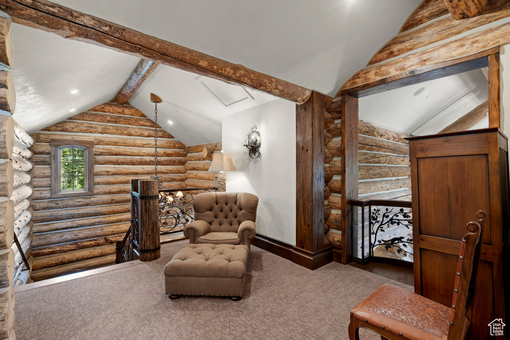 Sitting room featuring vaulted ceiling, log walls, carpet floors, and recessed lighting