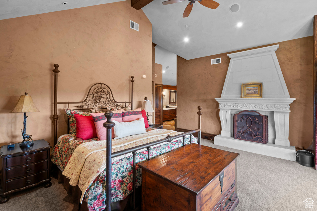 Carpeted bedroom with high vaulted ceiling, ensuite bathroom, beam ceiling, and a ceiling fan