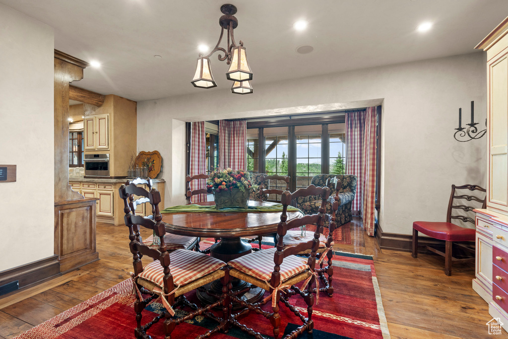 Dining area with light wood-type flooring and recessed lighting
