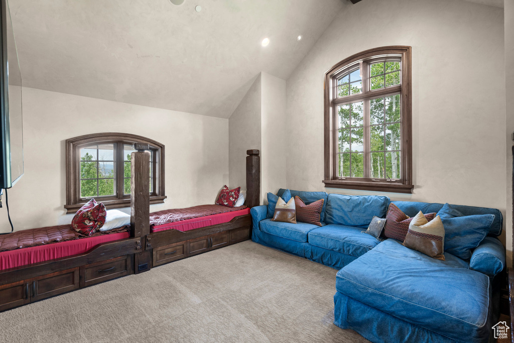 Carpeted bedroom featuring vaulted ceiling and recessed lighting