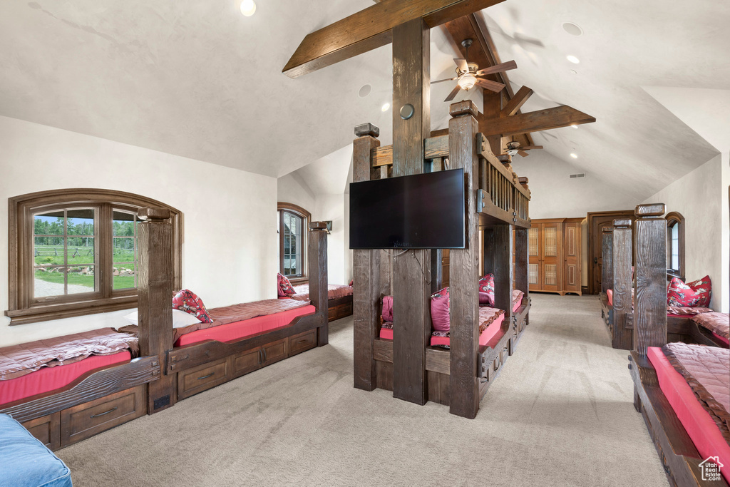 Carpeted bedroom featuring beam ceiling, high vaulted ceiling, arched walkways, and recessed lighting