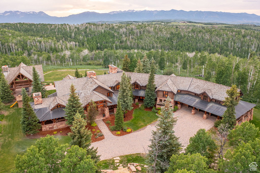 View from above of property featuring a forest and a mountain backdrop