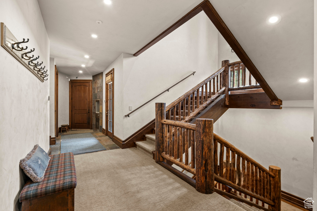 Carpeted entrance foyer featuring recessed lighting and stairway