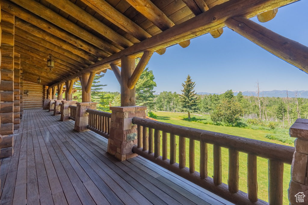 Wooden deck with a yard and a mountain view
