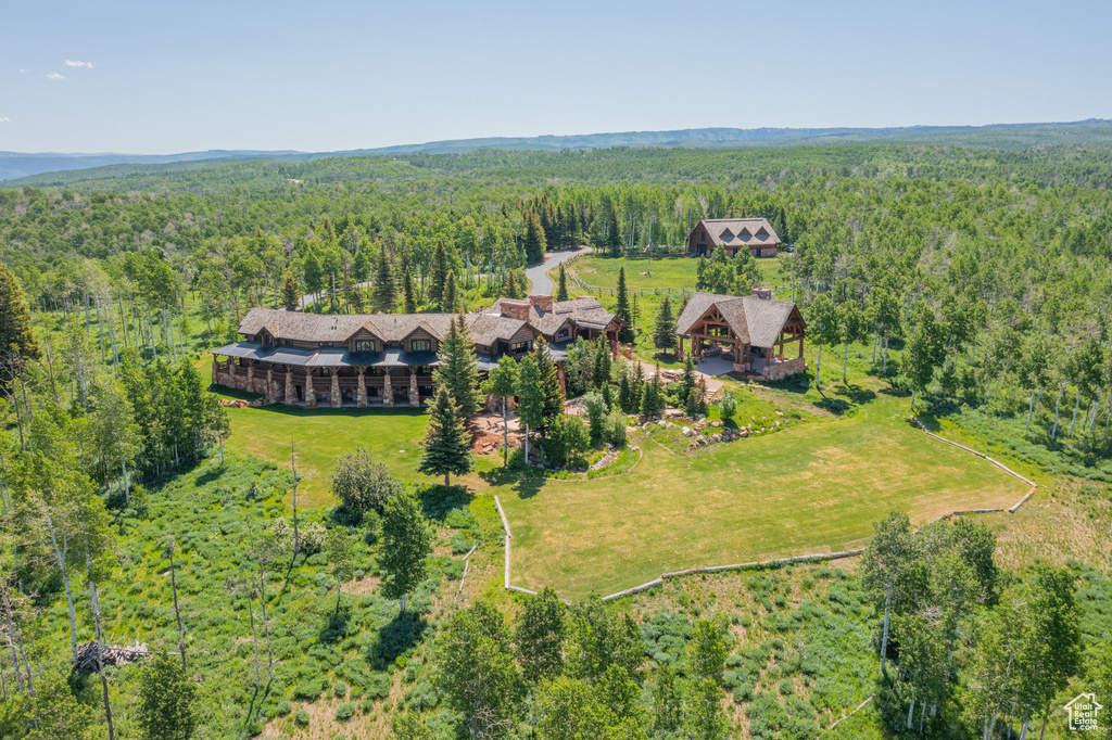 View from above of property featuring a heavily wooded area