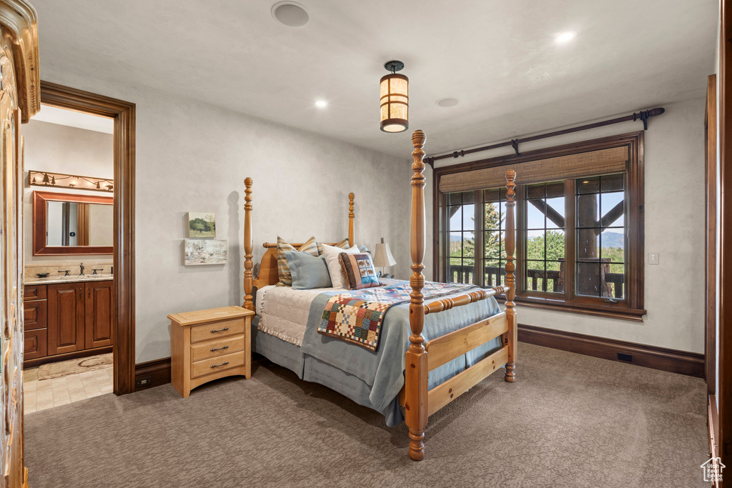 Bedroom with light colored carpet, ensuite bathroom, access to outside, and recessed lighting