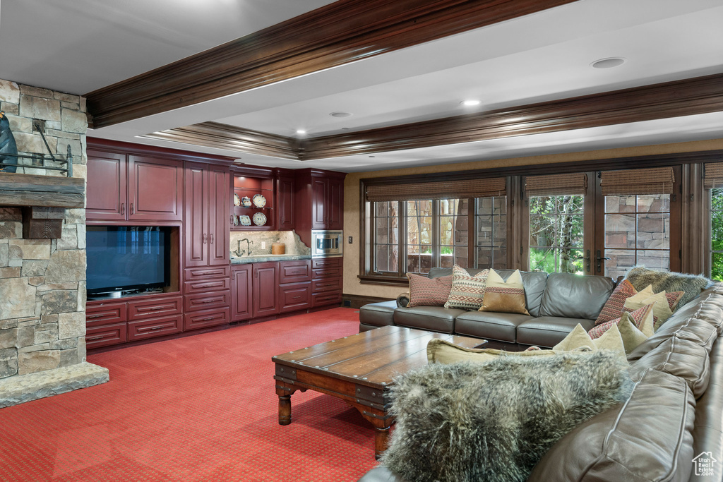 Living room featuring light carpet and ornamental molding