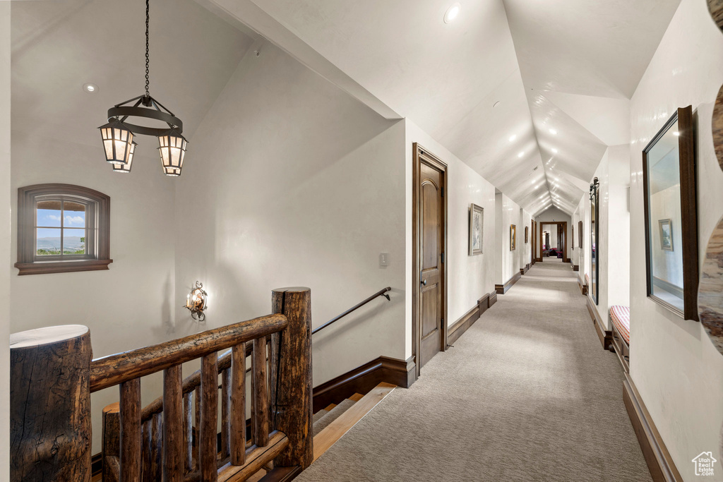 Corridor featuring vaulted ceiling, an upstairs landing, a chandelier, carpet floors, and recessed lighting