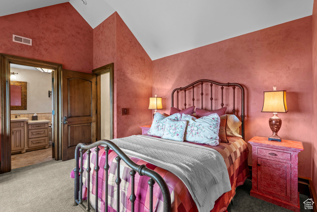 Bedroom featuring light carpet, high vaulted ceiling, and connected bathroom