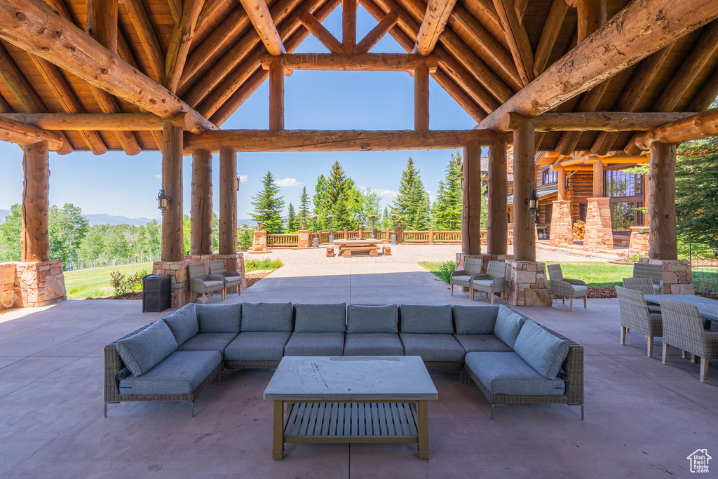 View of patio with a gazebo, an outdoor living space with a fireplace, and a mountain view