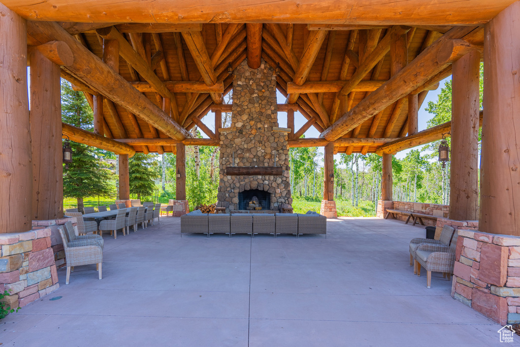 View of patio / terrace with an outdoor living space with a fireplace and a gazebo
