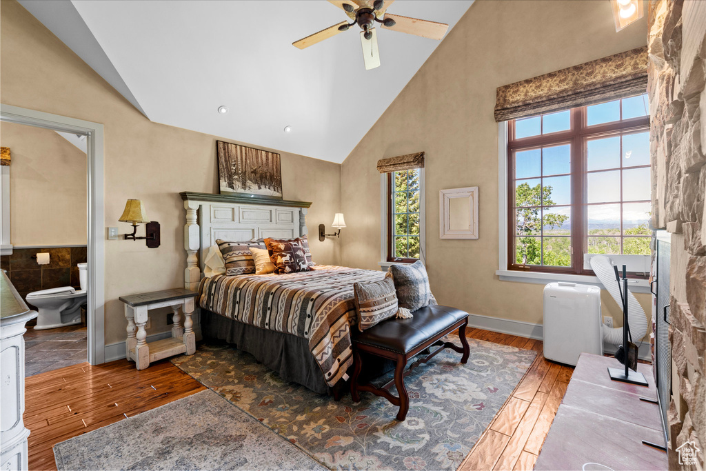 Bedroom featuring wood finished floors and high vaulted ceiling