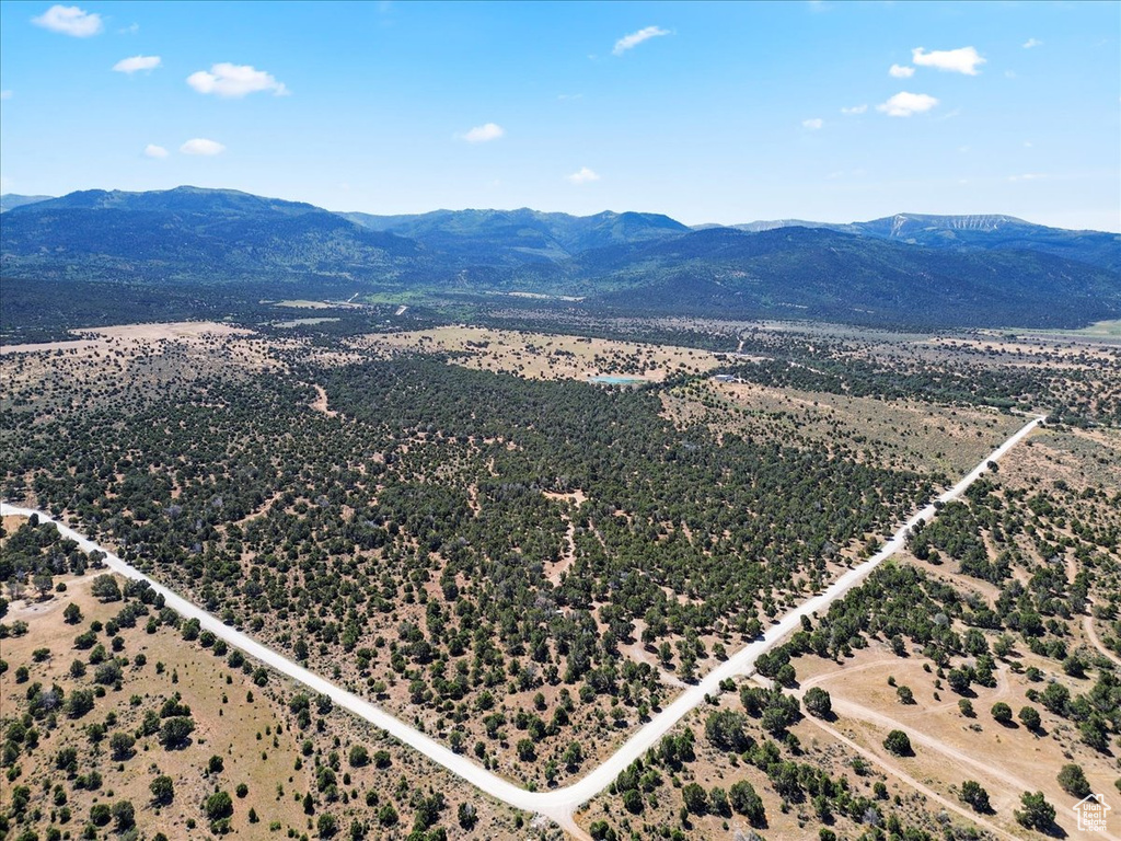 Aerial overview of property\'s location with a mountainous background and property parcel outlined