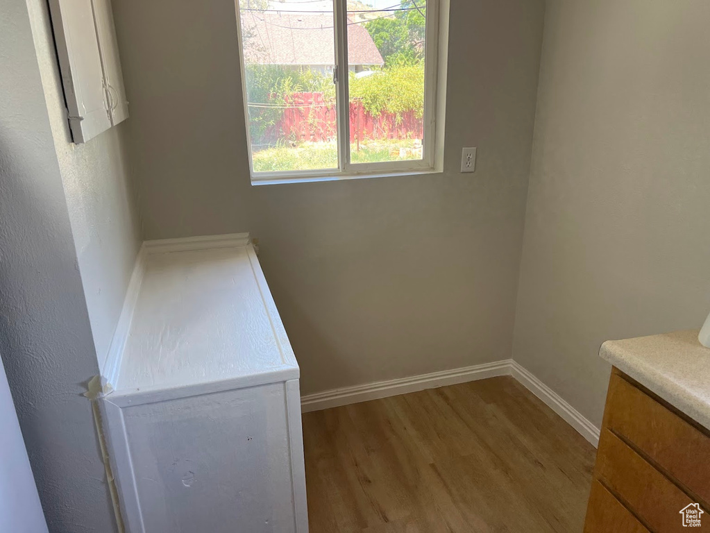 Washroom with wood finished floors and baseboards