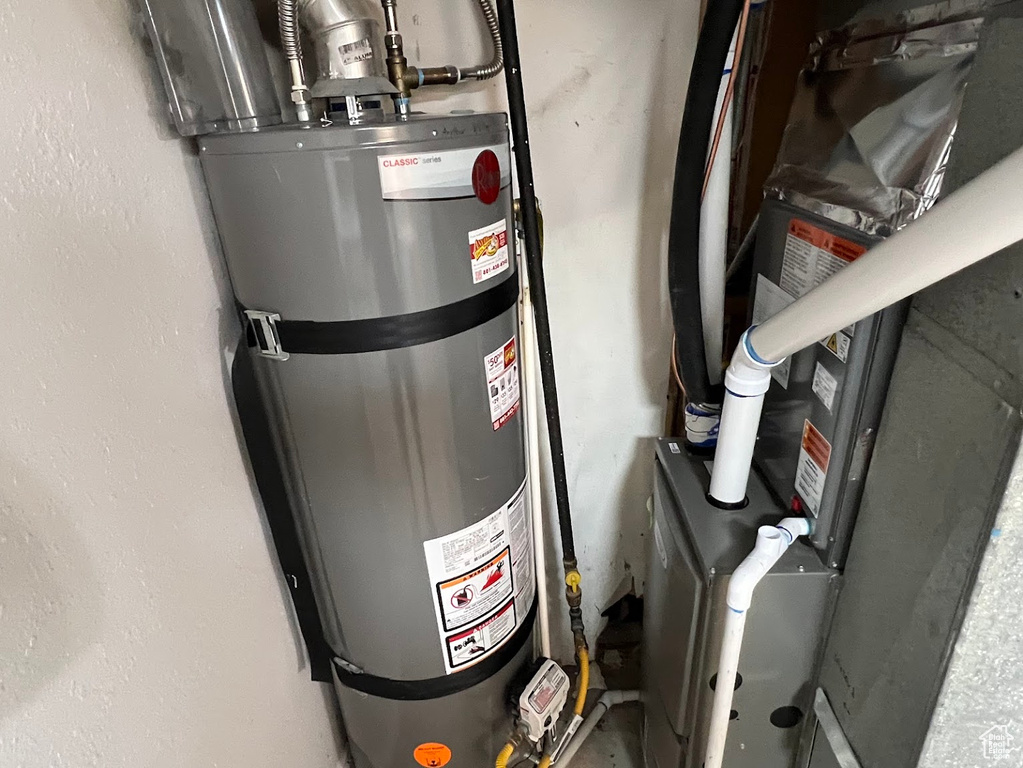 Utility room with strapped water heater and heating unit