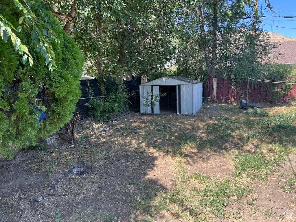 View of yard with a storage unit