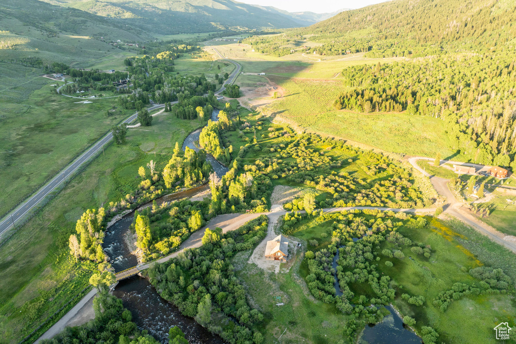 Aerial view of property and surrounding area with a mountain backdrop