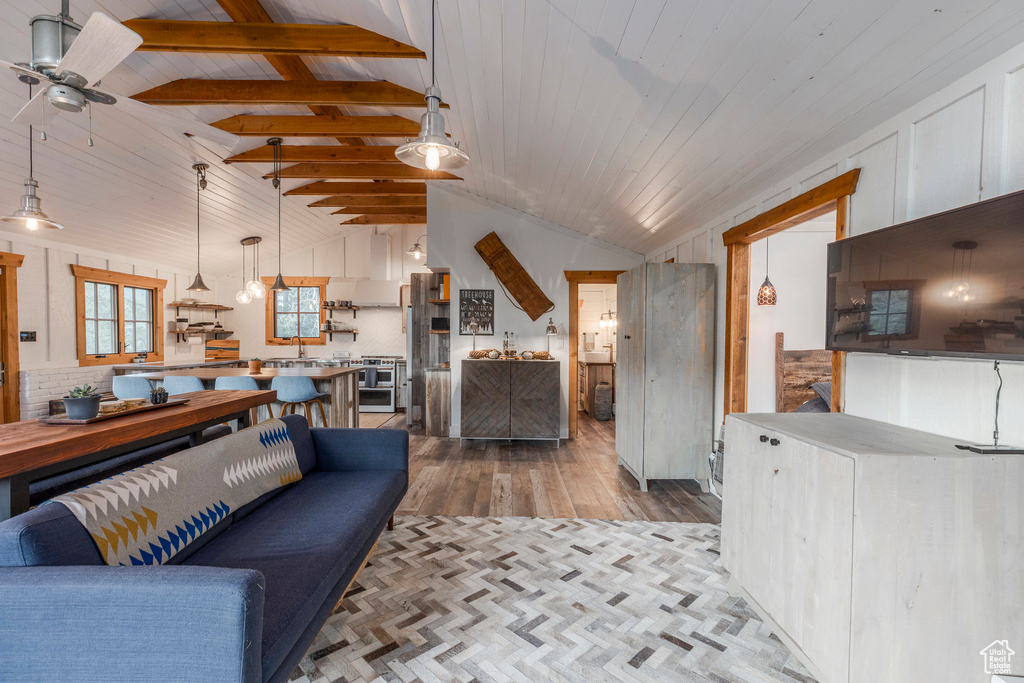 Living area with wood finished floors, ceiling fan, and wooden ceiling