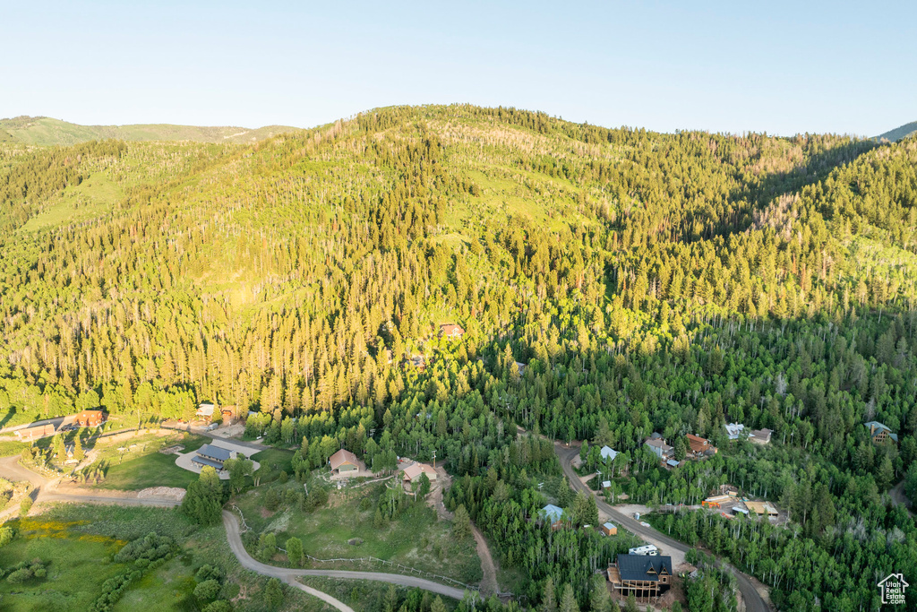 Aerial view of property and surrounding area featuring a forest