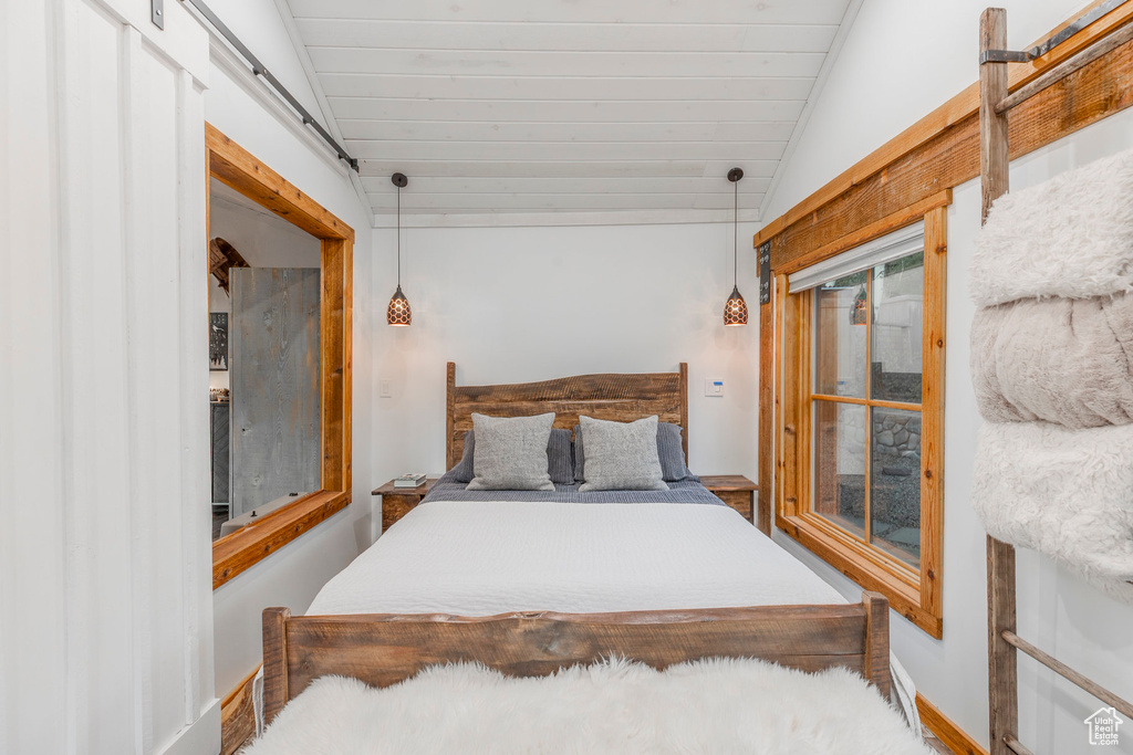Bedroom with lofted ceiling and wood ceiling