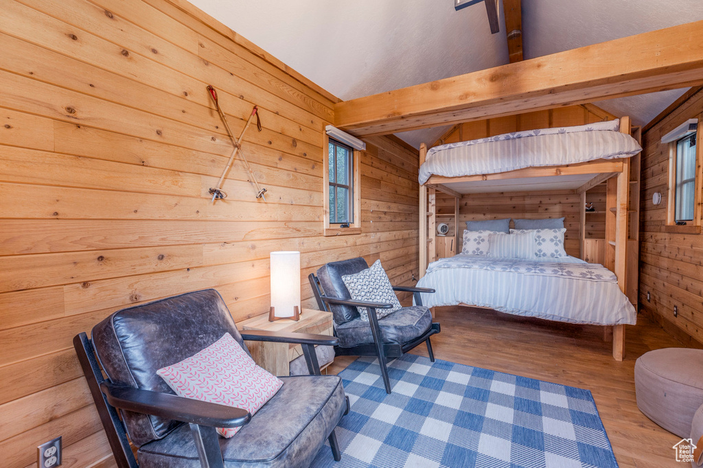 Bedroom with wood walls and wood finished floors