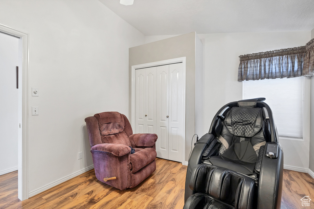 Sitting room featuring vaulted ceiling and light wood-type flooring