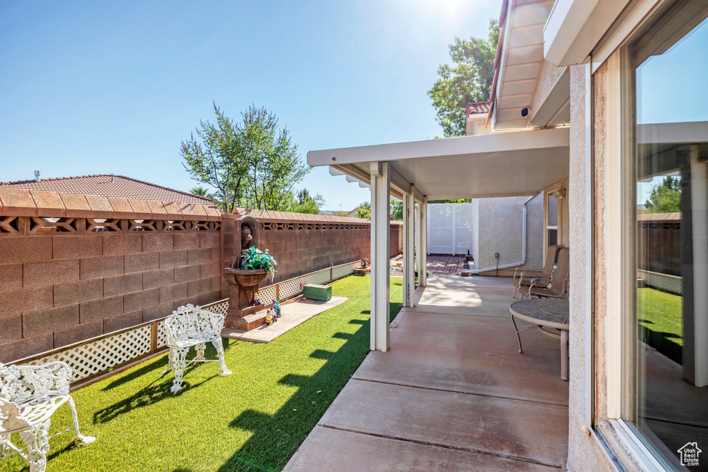 Fenced backyard featuring a patio