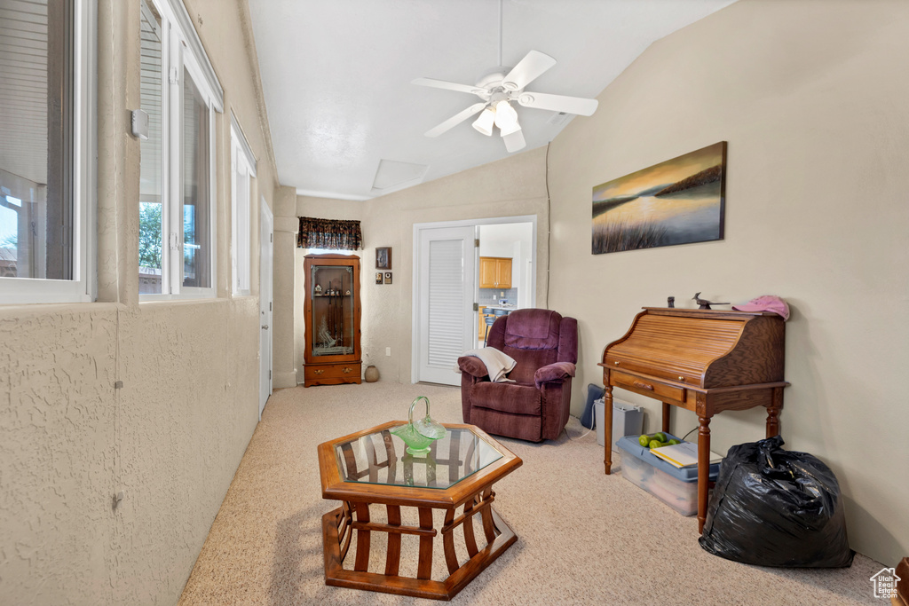 Living room with lofted ceiling and a ceiling fan
