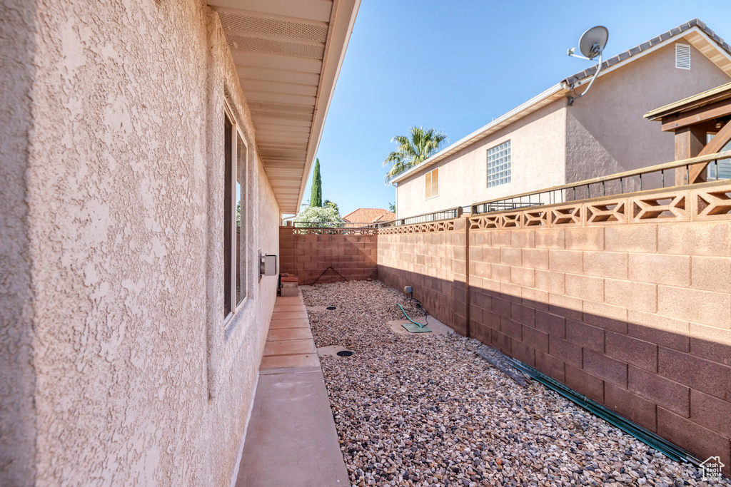 View of home\'s exterior featuring stucco siding and a fenced backyard