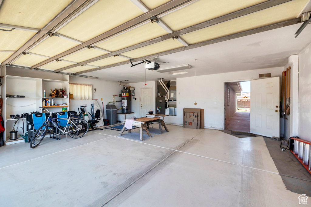 Garage with water heater and a garage door opener