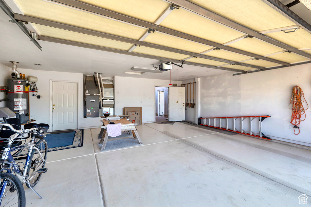 Garage with gas water heater and a garage door opener