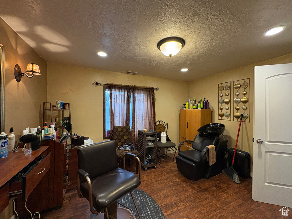 Office area with a textured ceiling, dark wood-style floors, and recessed lighting