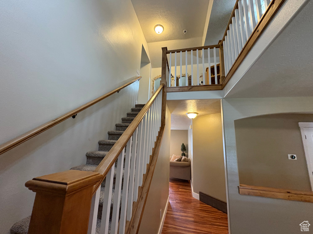 Stairs featuring wood finished floors and baseboards