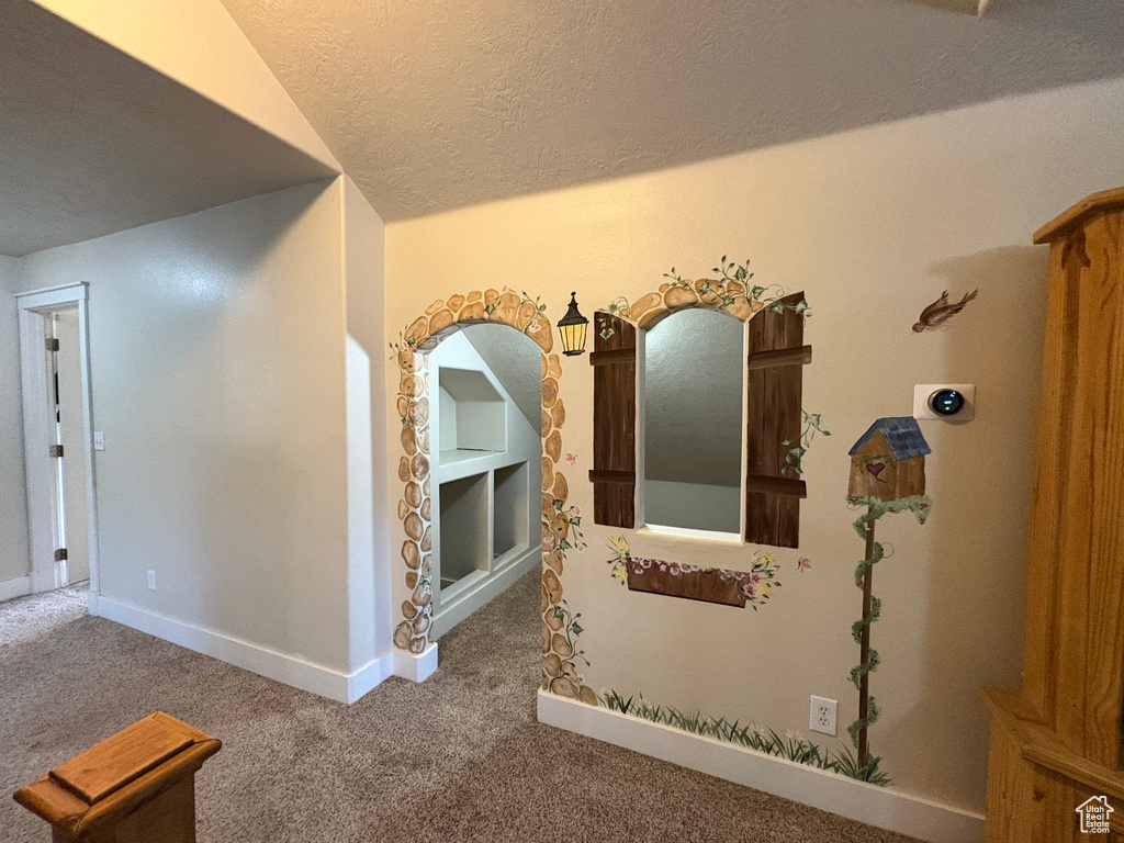 Corridor featuring carpet flooring and a textured ceiling