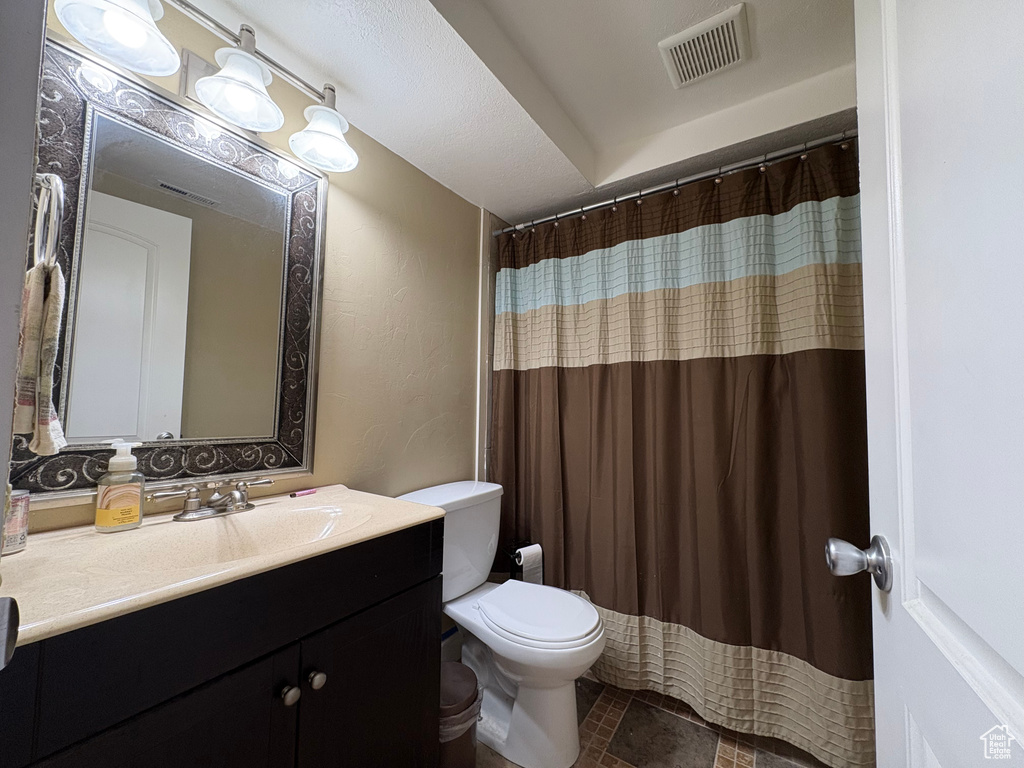Bathroom featuring vanity and curtained shower