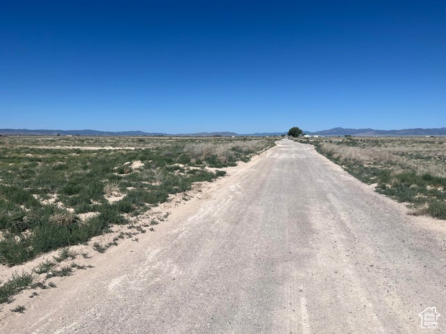 View of dirt / gravel road featuring a mountain view