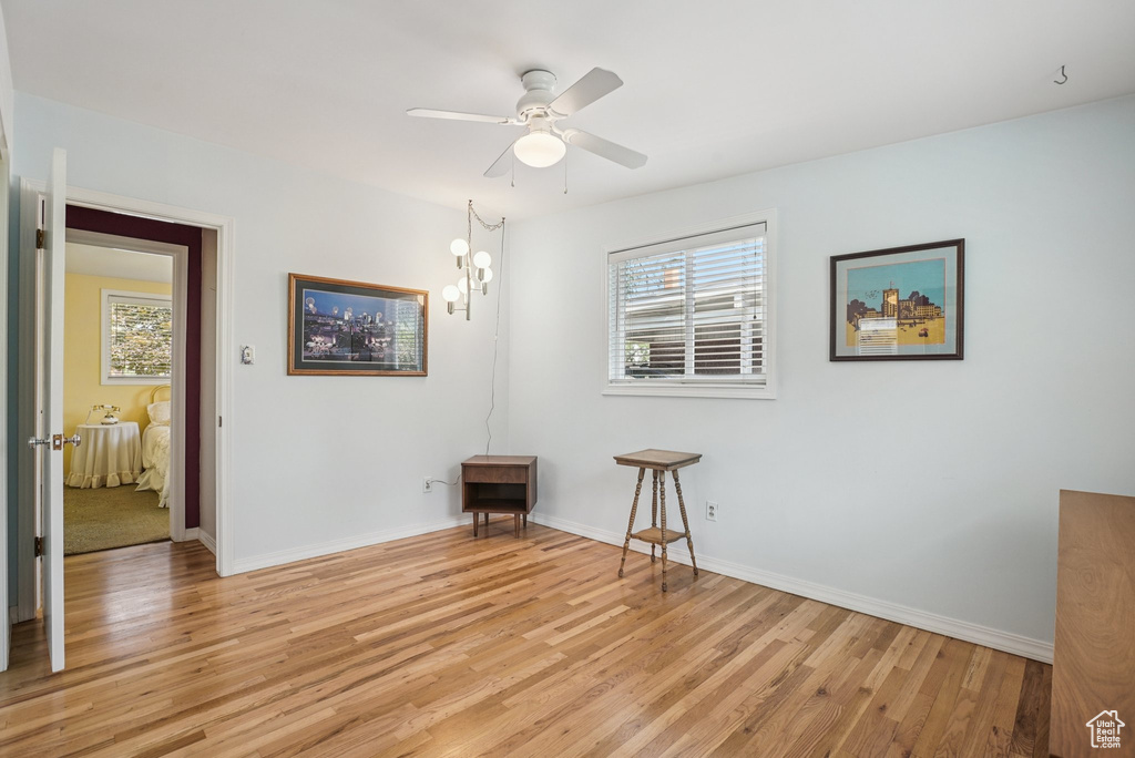Unfurnished room with light wood finished floors and a ceiling fan