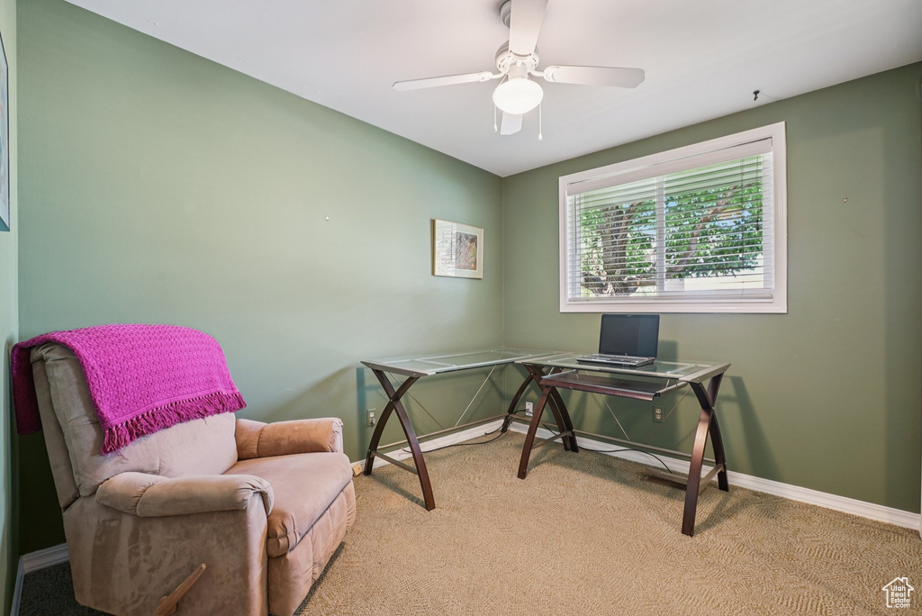 Office space with light colored carpet and ceiling fan