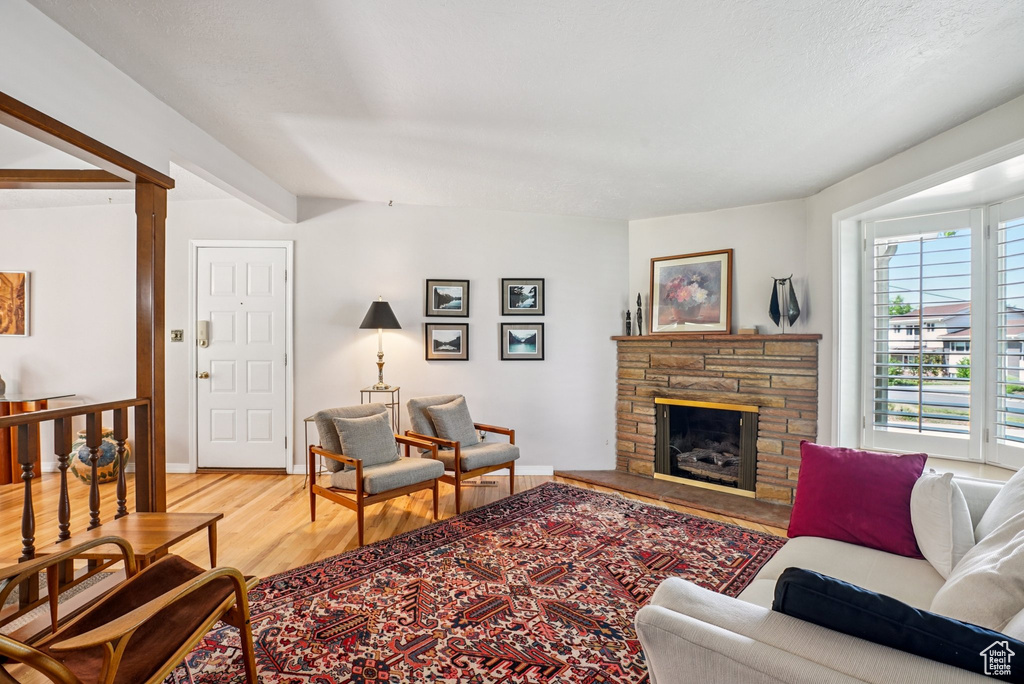 Living area with light wood-style floors and a fireplace